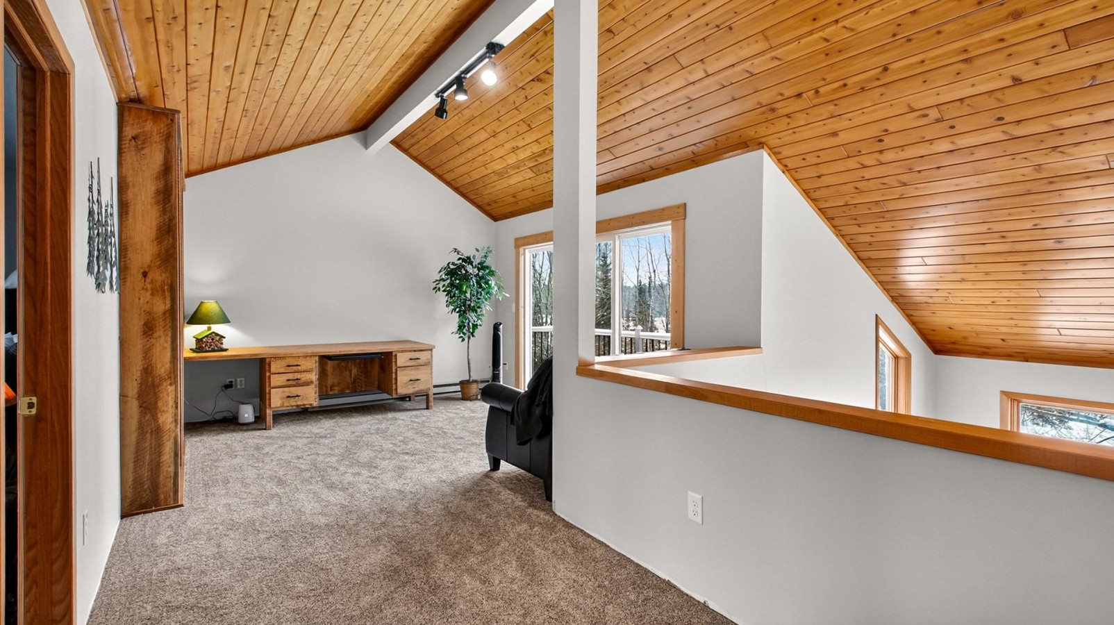 Retreat to your private loft workspace, where wood beams frame peaceful forest views and natural light inspires productivity.