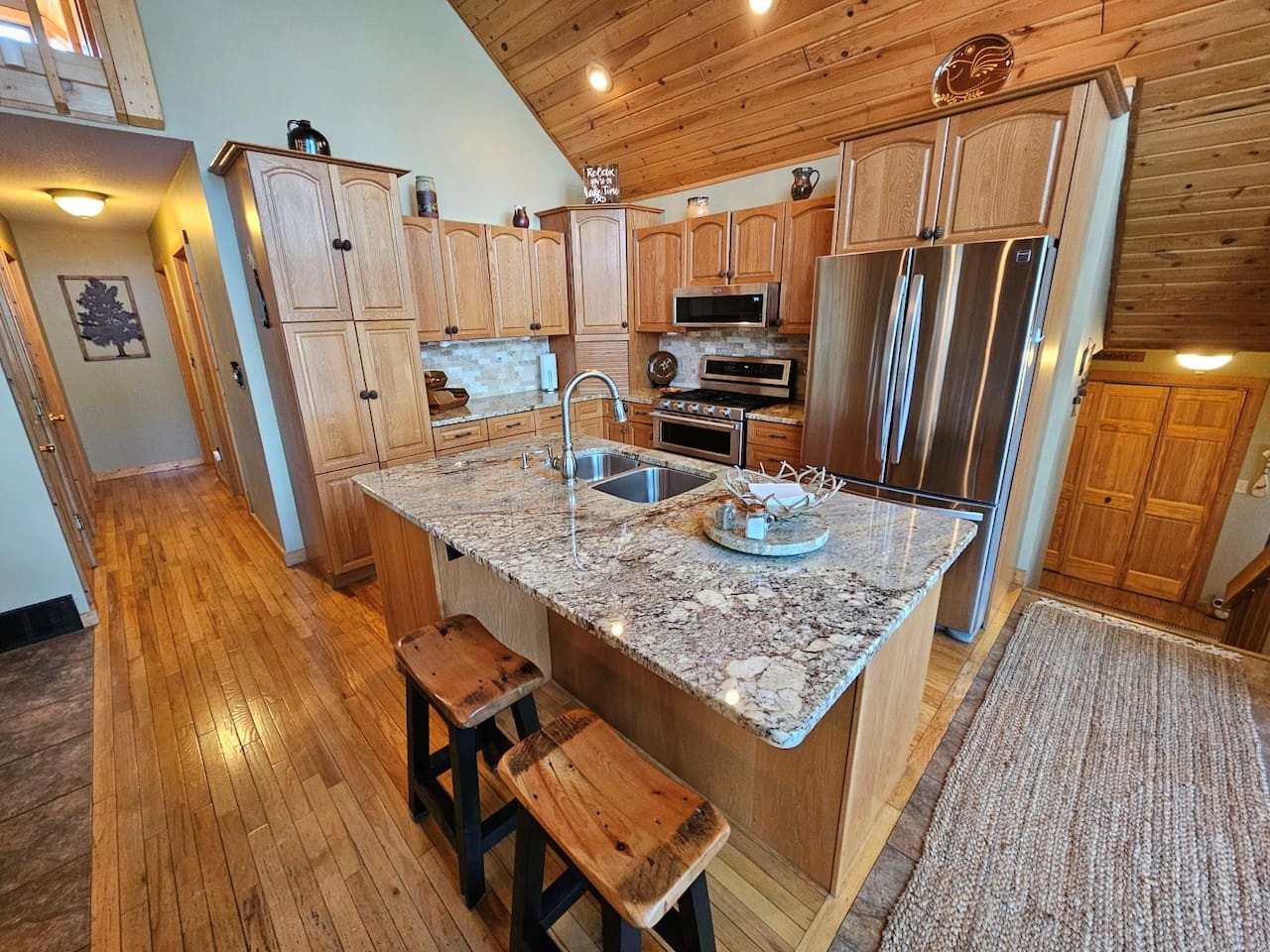 Your spacious kitchen awaits with granite countertops, premium stainless appliances, and a perfect island for cooking together.
