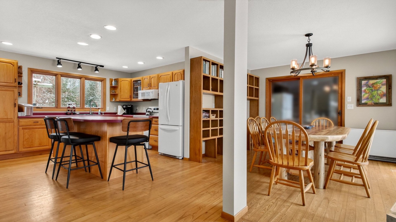 Your spacious kitchen and dining area flows seamlessly together, featuring warm wood finishes, modern appliances, and plenty of room for cooking and gathering.