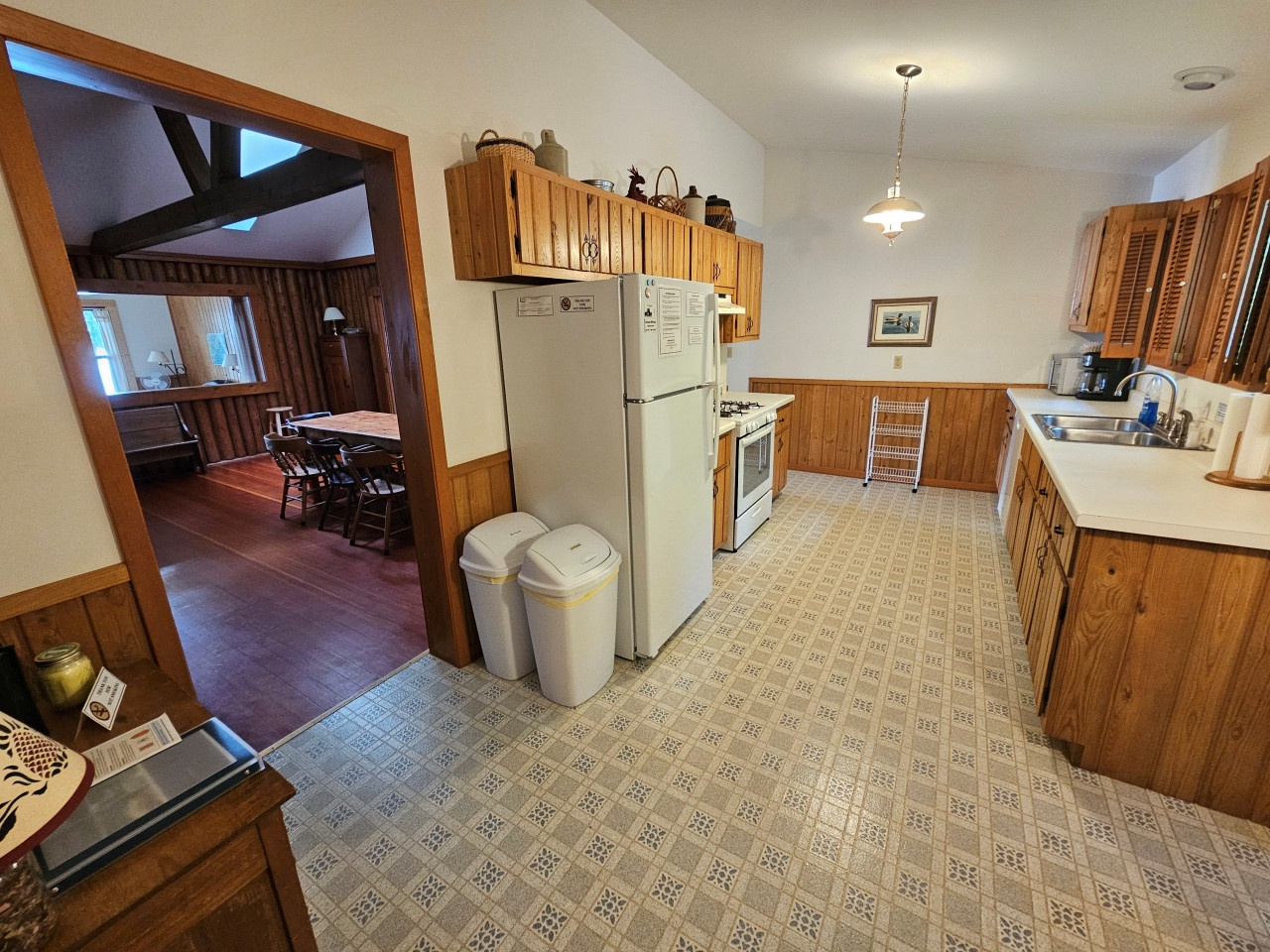 Your fully equipped kitchen offers warm wood cabinets, modern appliances, and plenty of counter space for preparing meals during your stay.