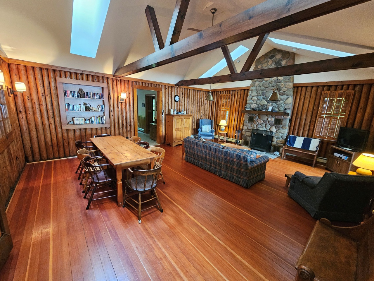 Relax in this stunning rustic cabin with exposed beams, stone fireplace, and cozy dining space where you'll create lasting memories.