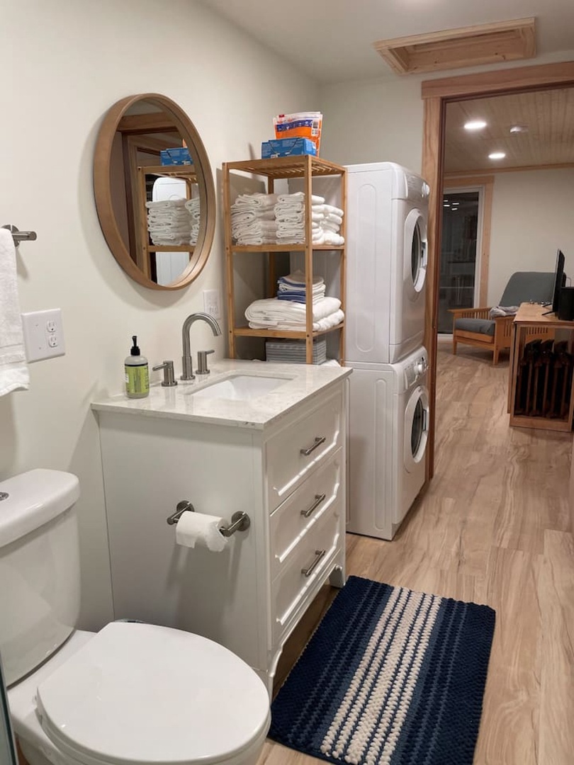 Your thoughtfully designed laundry space combines convenience with coastal charm, featuring fresh linens and modern appliances.