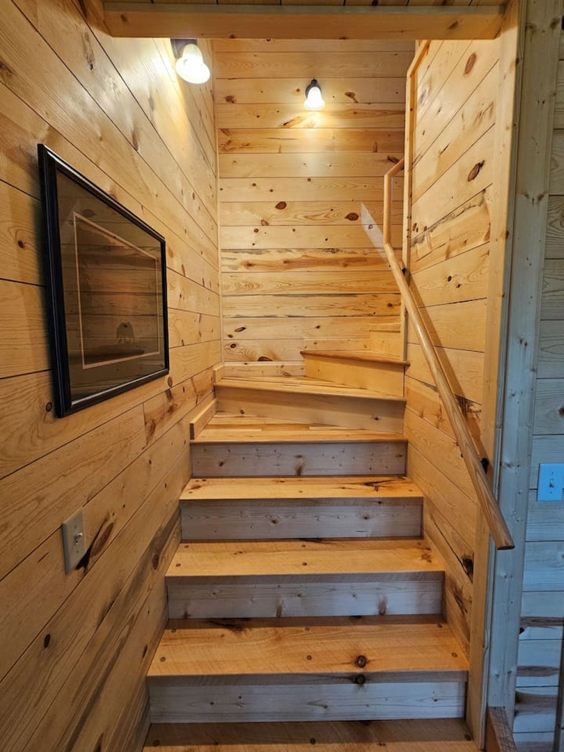Climb the warm pine staircase that leads to your cozy retreat, where rustic charm meets mountain elegance.