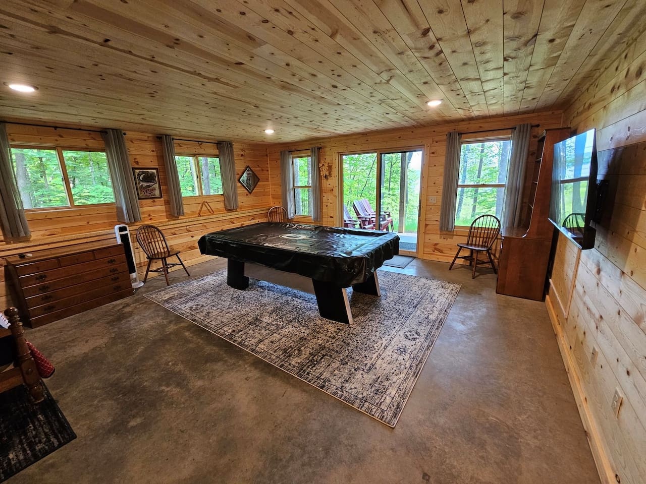Challenge your group to exciting games in your private rustic game room, surrounded by forest views through picture windows.