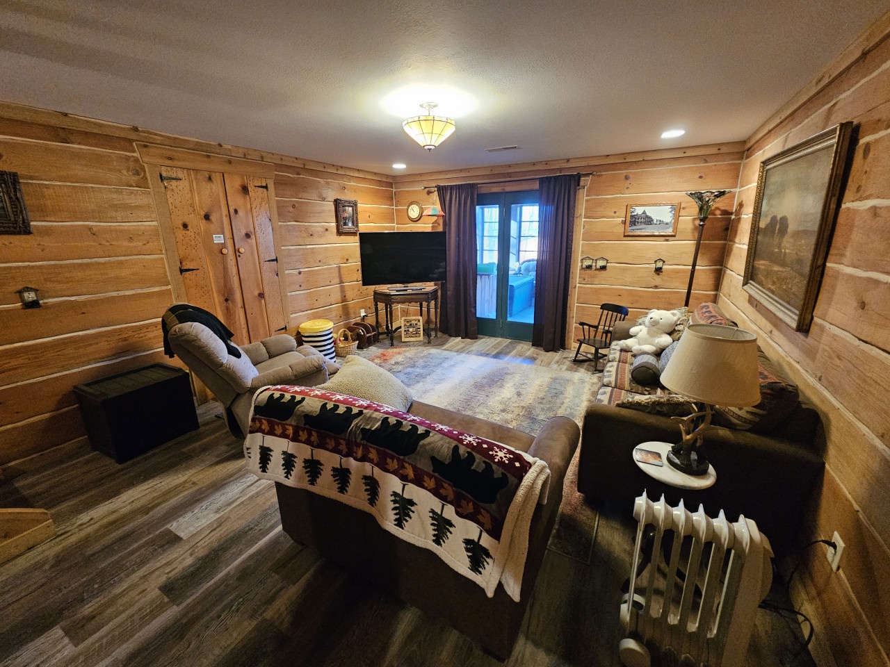 Unwind in your cozy log cabin retreat with rustic charm, plush seating, and warm lighting perfect for relaxing evenings.