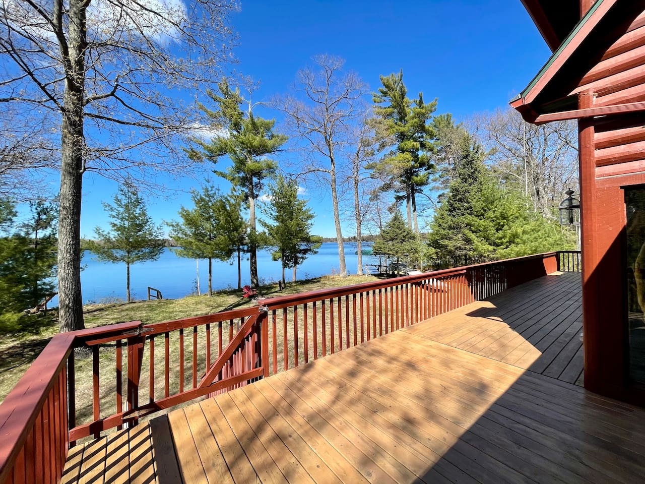 Unwind on your private deck overlooking tranquil lake waters, where morning coffee tastes even better surrounded by towering pines and endless blue skies.