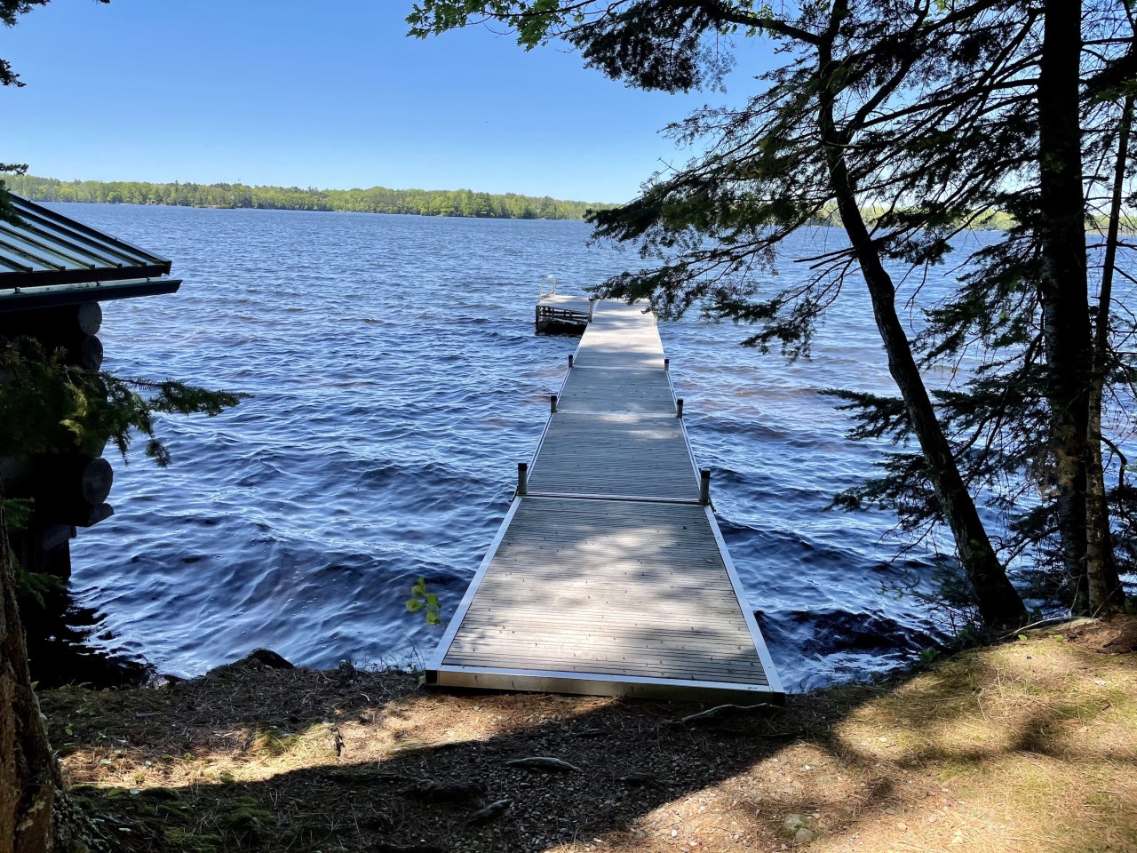 Step onto your private dock and dive into crystal-clear waters surrounded by peaceful forest views.
