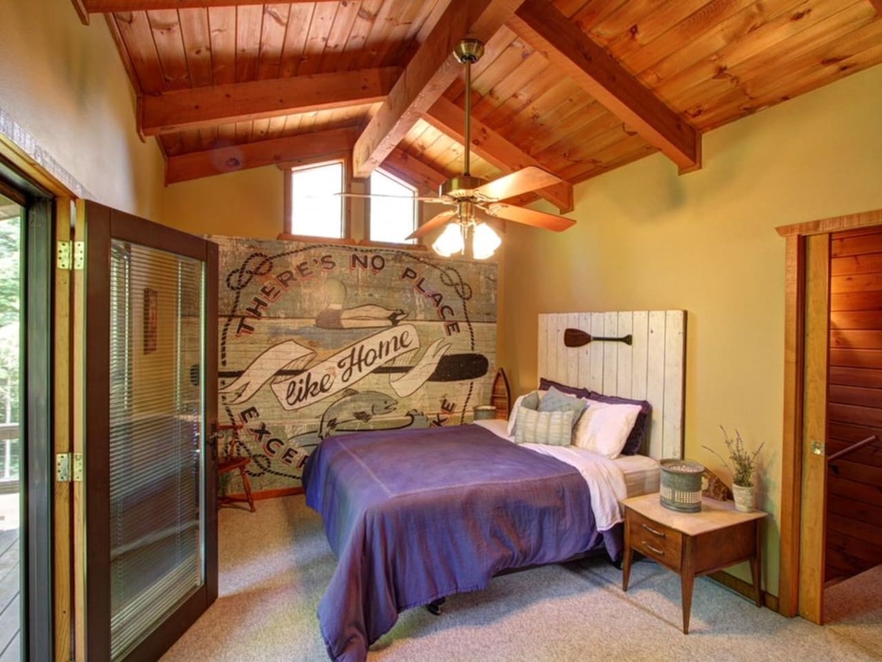 Drift off under soaring wood beams in your cozy retreat, where vintage charm meets modern comfort in this thoughtfully designed bedroom.