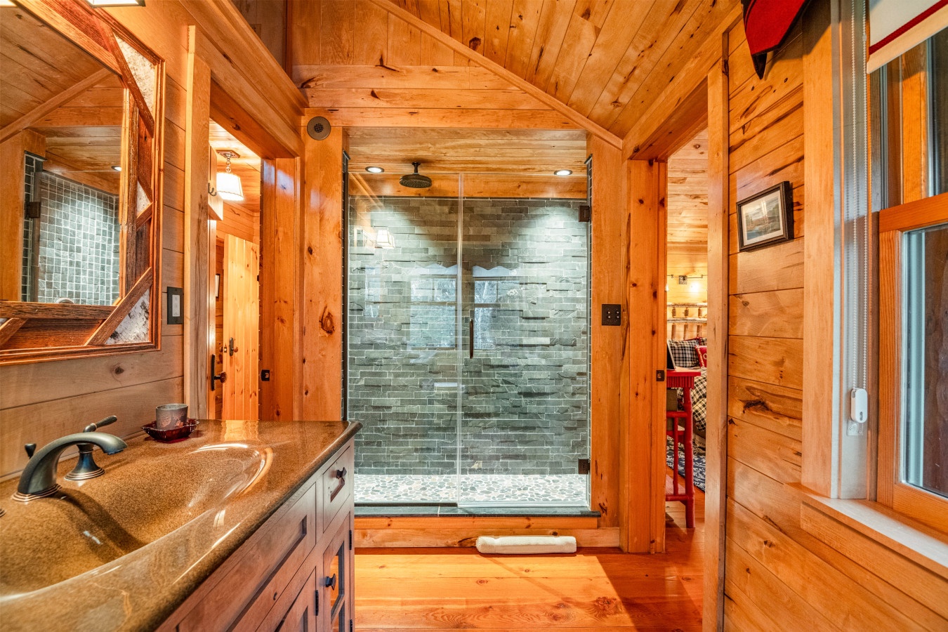 Luxurious stone-tile shower and rustic wood finishes create your perfect mountain retreat bathroom.