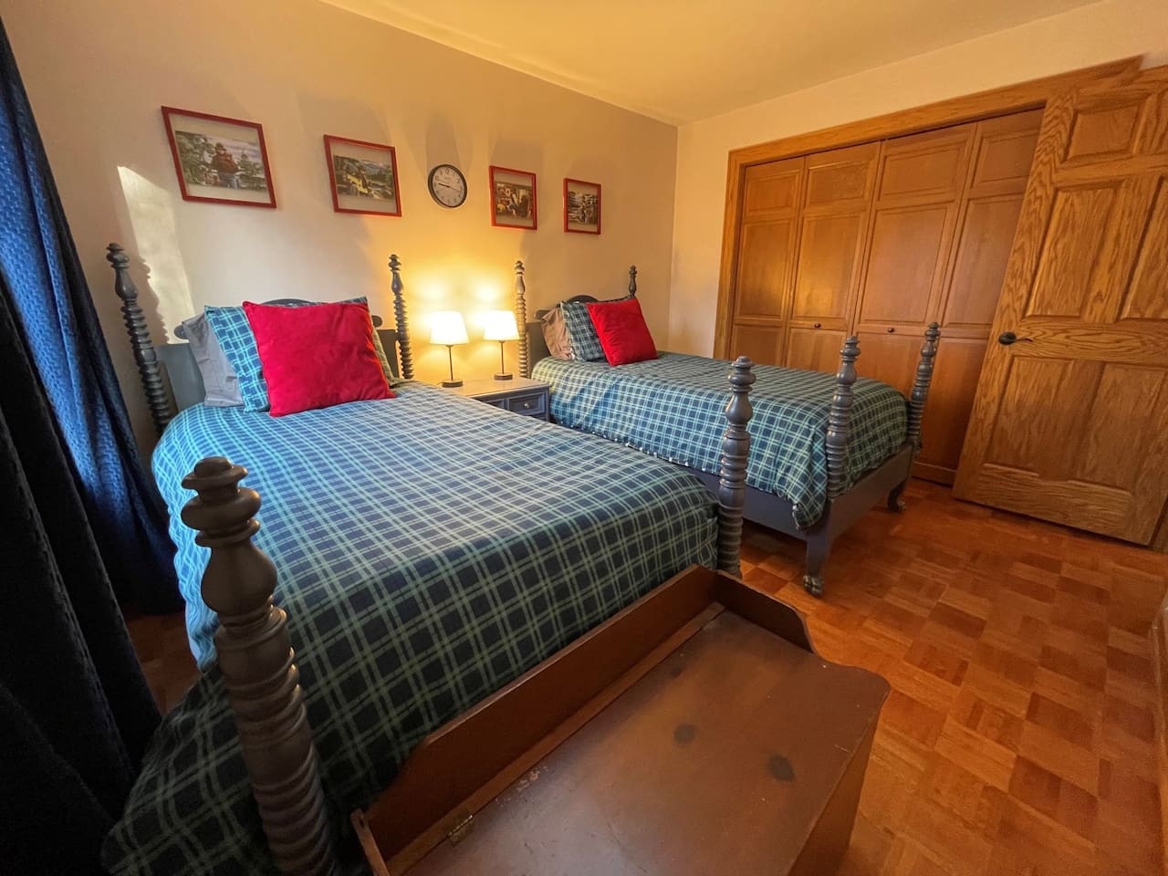 Rest in classic comfort with twin beds featuring cozy plaid linens and vintage charm in your welcoming bedroom.