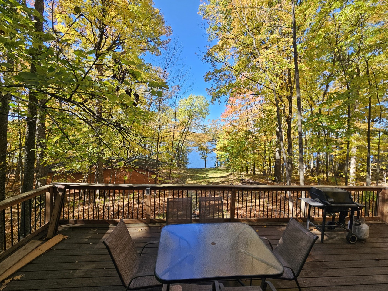 Your private deck offers stunning autumn views through golden canopy trees, perfect for morning coffee or evening barbecues surrounded by nature's vibrant colors.
