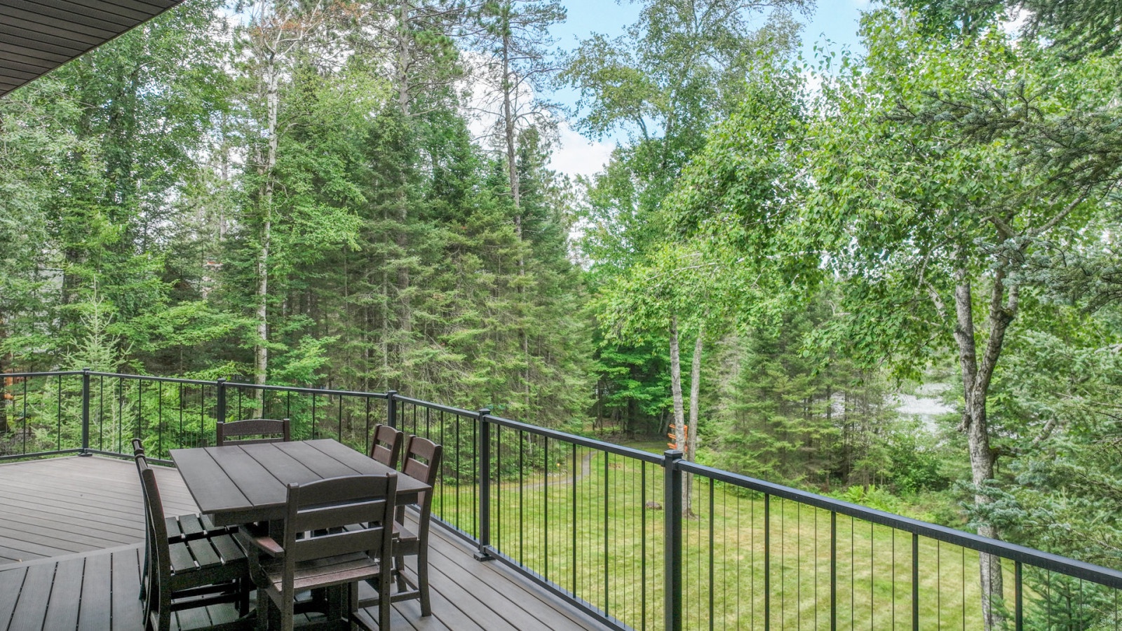 Enjoy your morning coffee at this peaceful deck table, surrounded by towering trees and nature's tranquil embrace.
