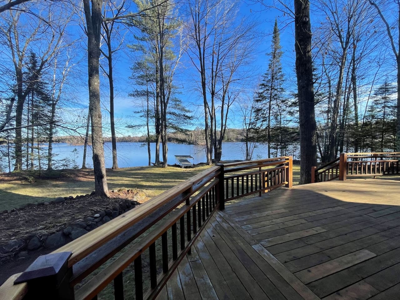 Step onto your private deck and breathe in the crisp lake air while soaking up stunning water views through towering trees.