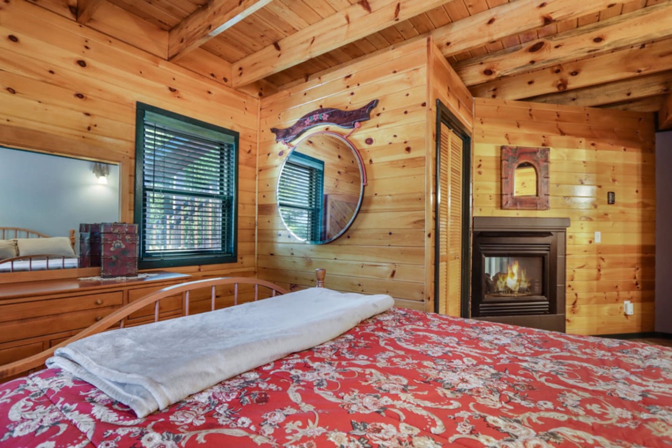 Drift off to sleep surrounded by warm wood walls and the gentle glow of your private fireplace in this cozy mountain bedroom.