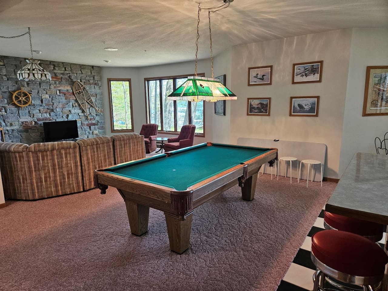 Challenge friends to a game of pool in your spacious recreation room, complete with cozy seating and rustic charm.
