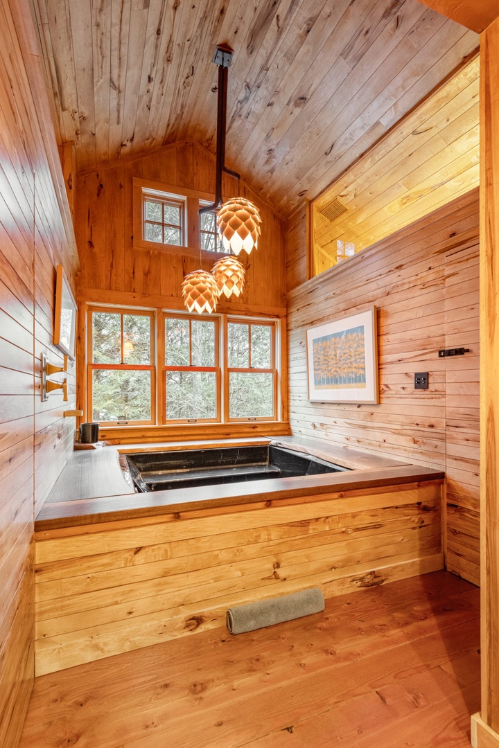 Soak in your private wood-wrapped spa tub while forest views fill the windows and artisan lighting creates the perfect ambiance.