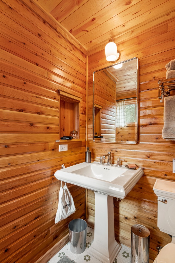 Step into your rustic retreat bathroom, where warm cedar walls create a cozy cabin atmosphere for refreshing mornings.