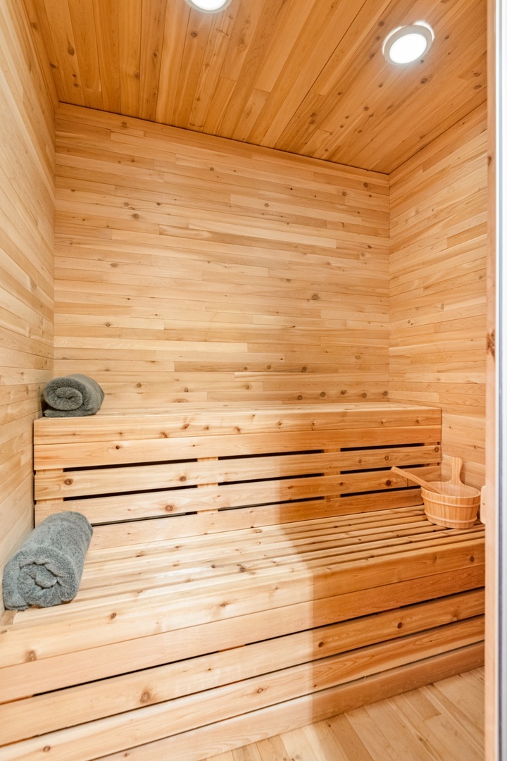 Step into your private sauna sanctuary, where warm cedar wood surrounds you with fresh towels waiting for pure relaxation.