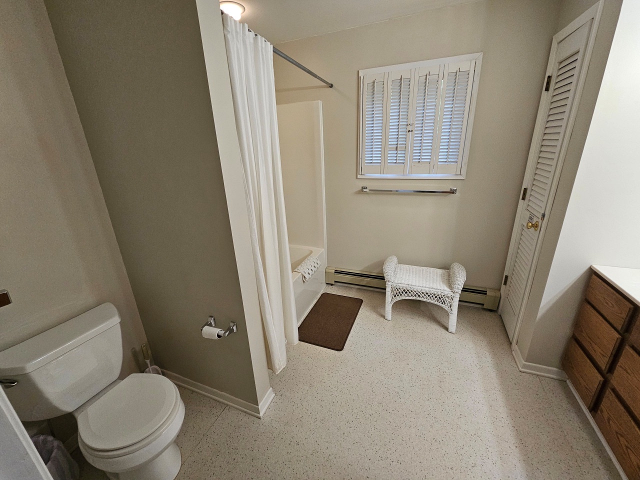 Refresh in your private bathroom with a relaxing tub-shower combo, natural light, and thoughtful amenities for your comfort.