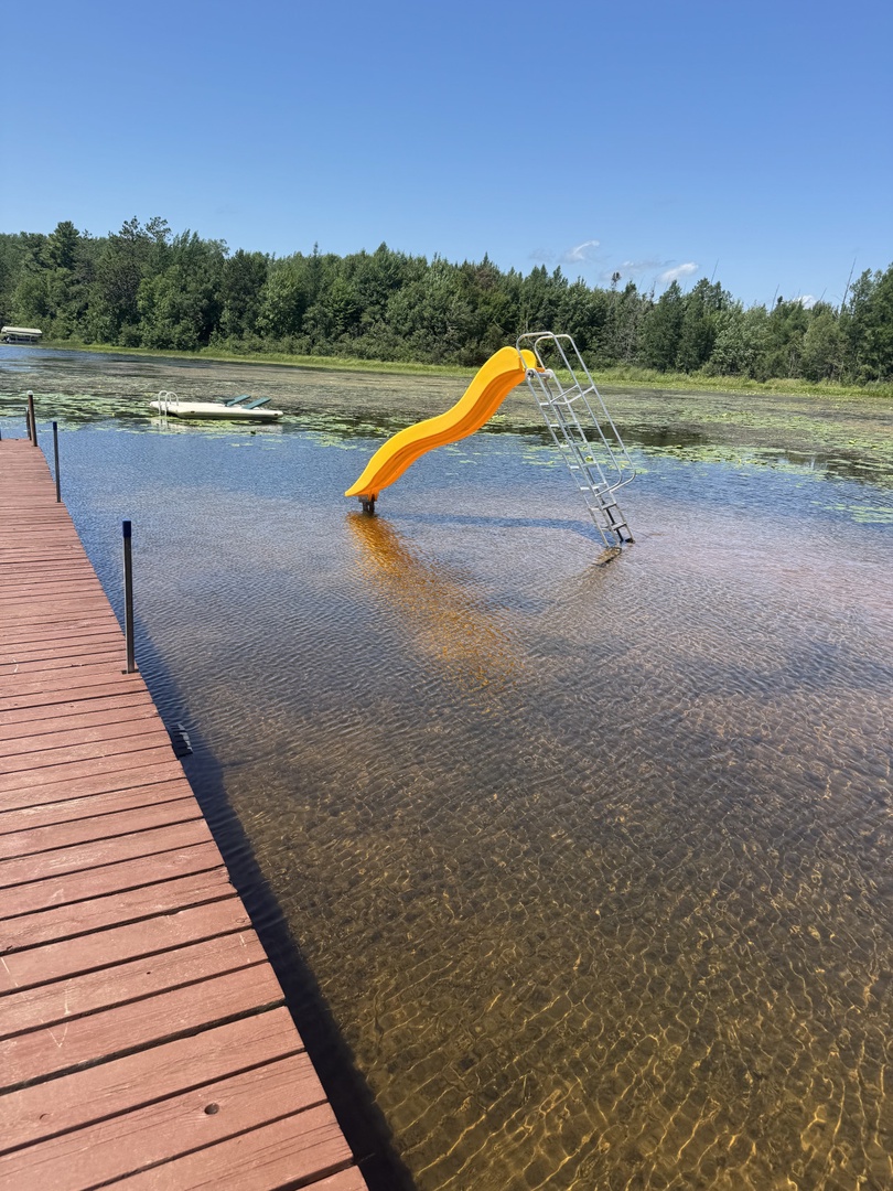 Private lake access with water slide and dock perfect for family fun and summer splashing.