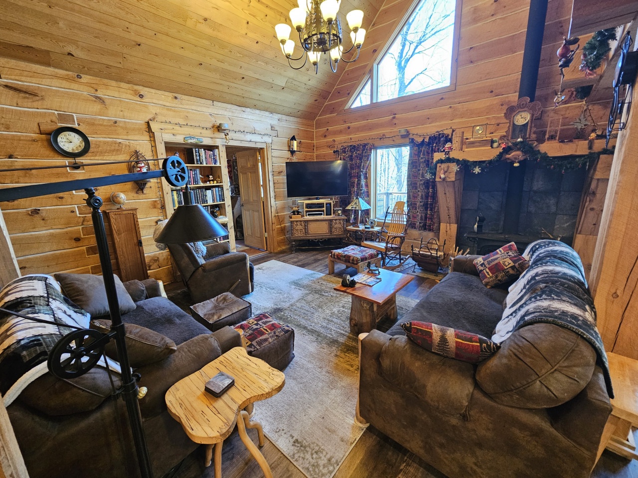 Cozy up in your rustic living room with exposed wood beams, crackling fireplace, and comfortable seating perfect for mountain evenings.