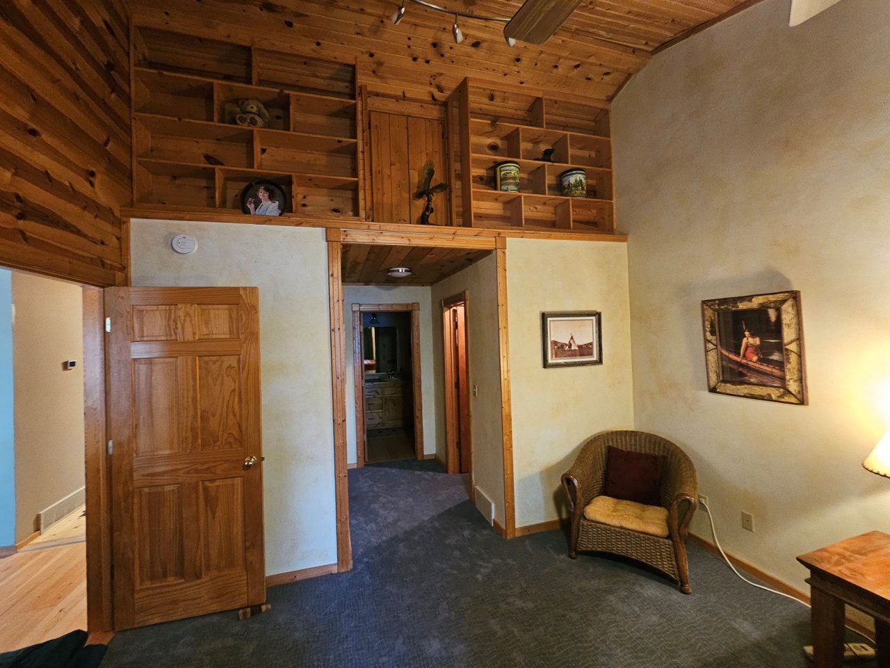 Relax in your cozy cabin-style retreat with vaulted wood ceilings, built-in shelving, and charming rustic touches that create the perfect mountain getaway atmosphere.