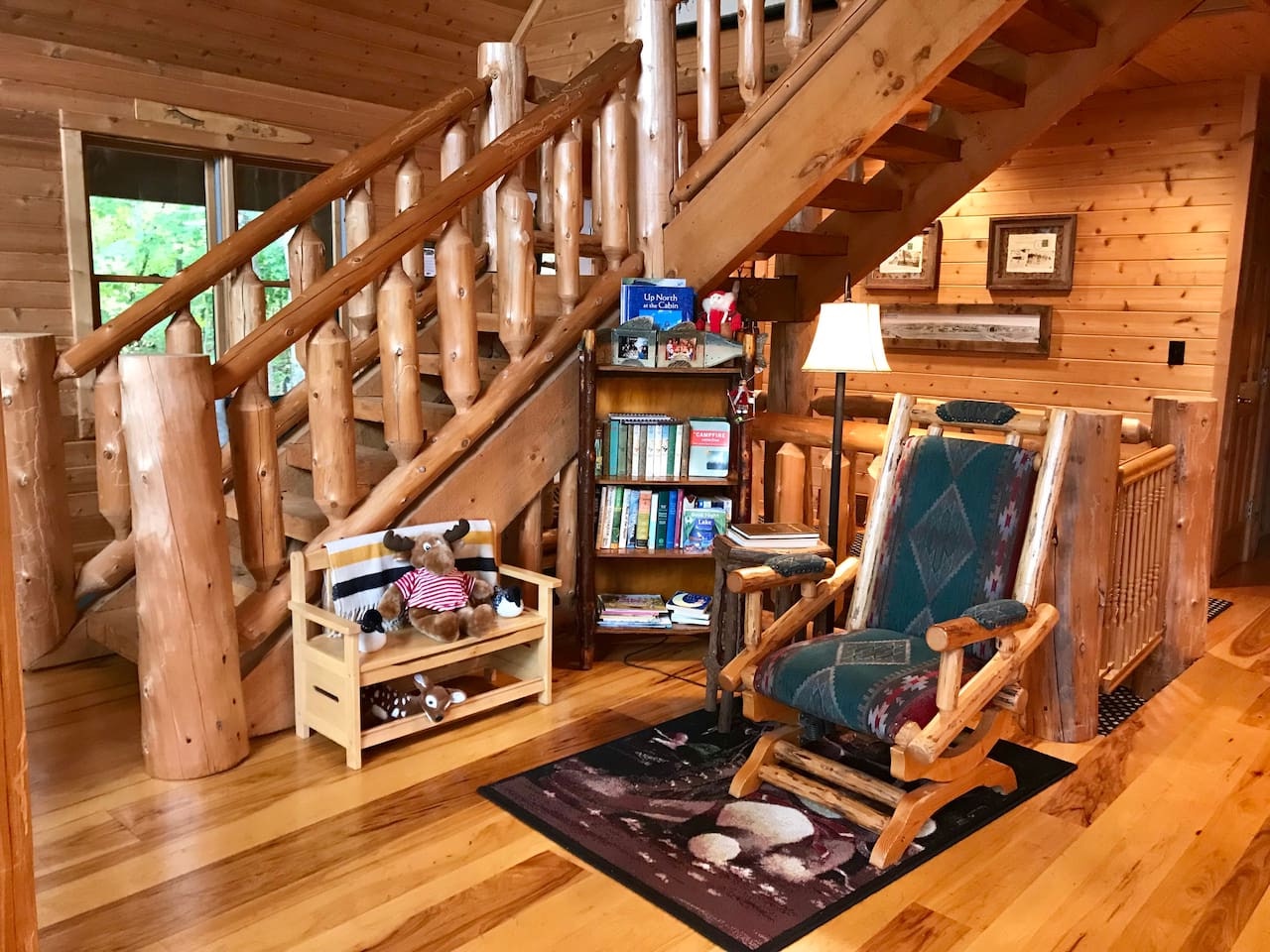 Unwind in your cozy reading nook with rustic log charm, where soft lighting and thoughtfully curated books create the perfect mountain retreat.