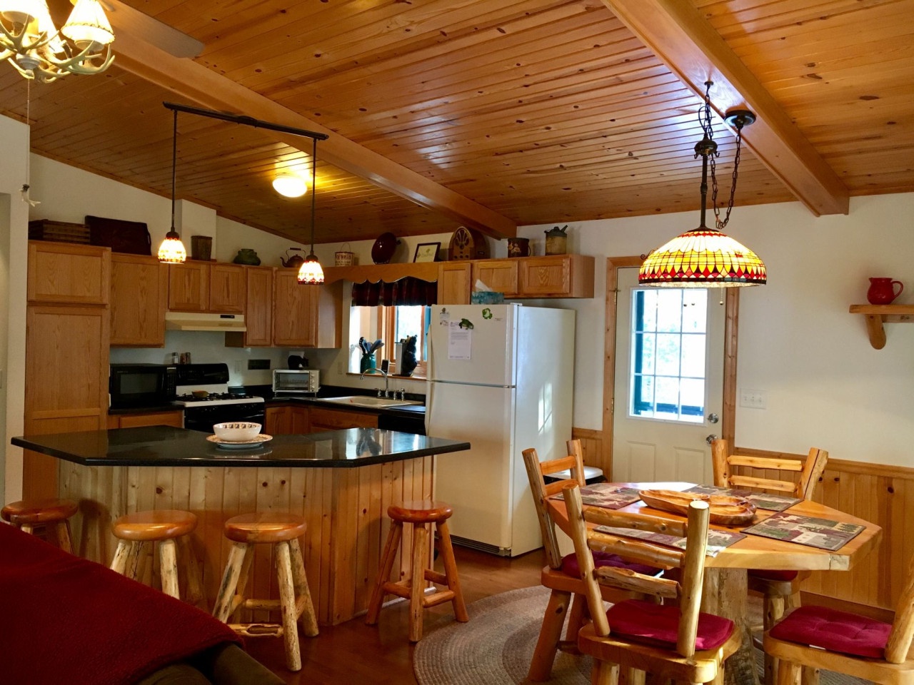 Gather around your rustic kitchen island for morning coffee or whip up meals with mountain charm in this cozy cabin space.