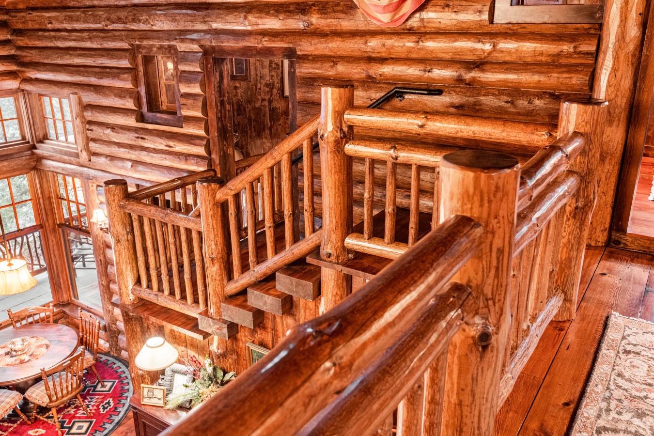 Rich wooden railings and rustic log walls create your perfect mountain retreat atmosphere with handcrafted charm throughout.
