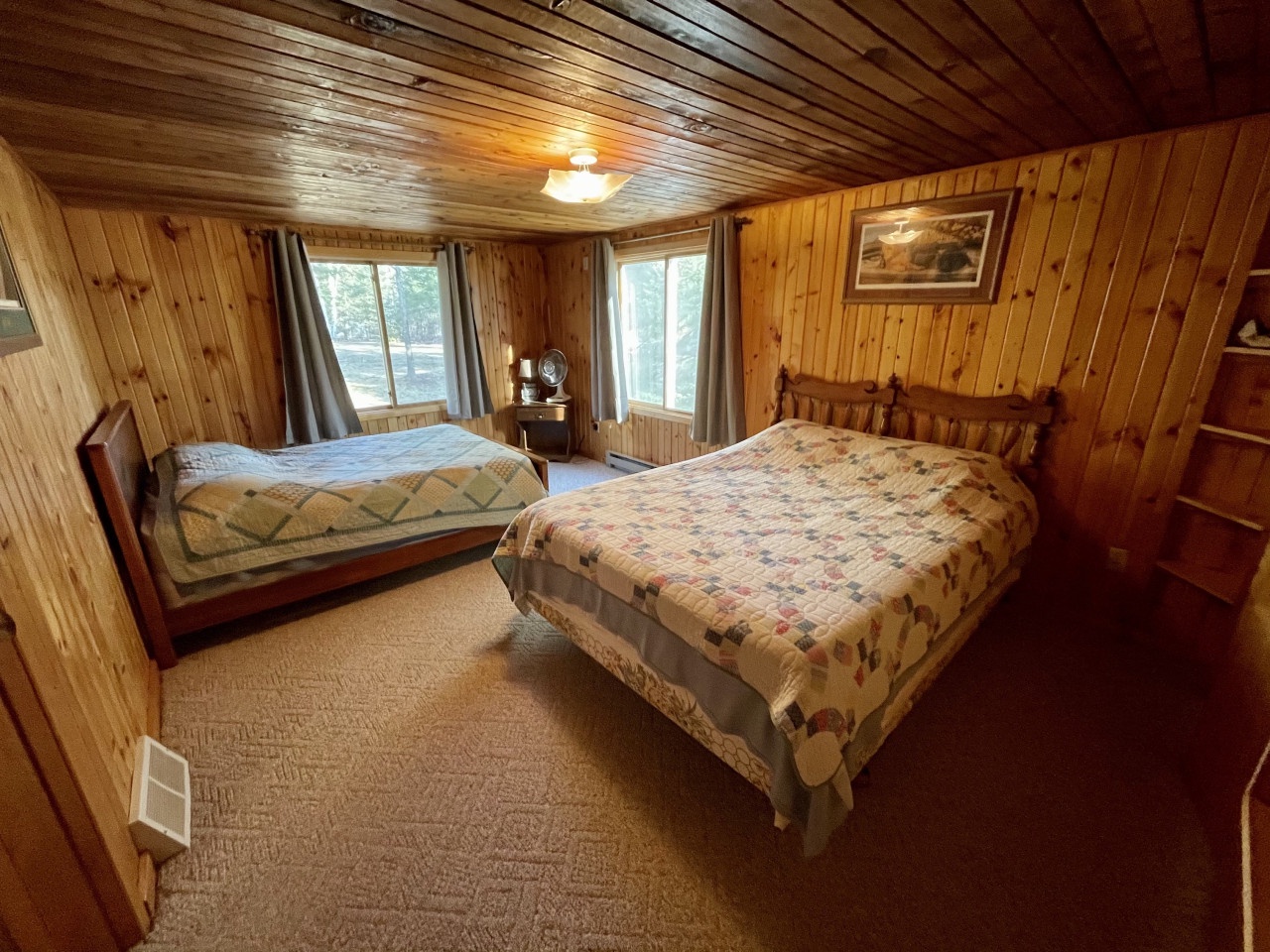 Drift off to sleep in your cozy log cabin bedroom, where warm wood walls and handcrafted quilts create the perfect rustic retreat.