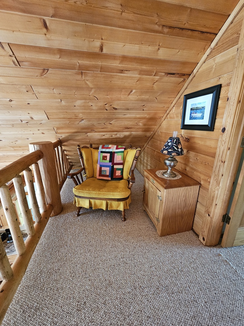 Curl up in your cozy reading nook with warm wood walls and soft lighting—perfect for quiet moments.