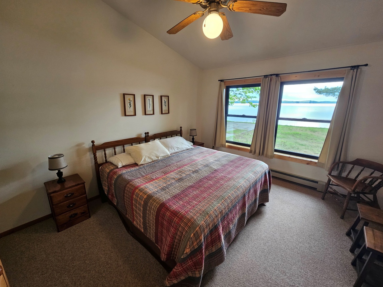 Wake up to stunning lake views from your cozy bedroom. The rustic wood furnishings and soft lighting create the perfect retreat.