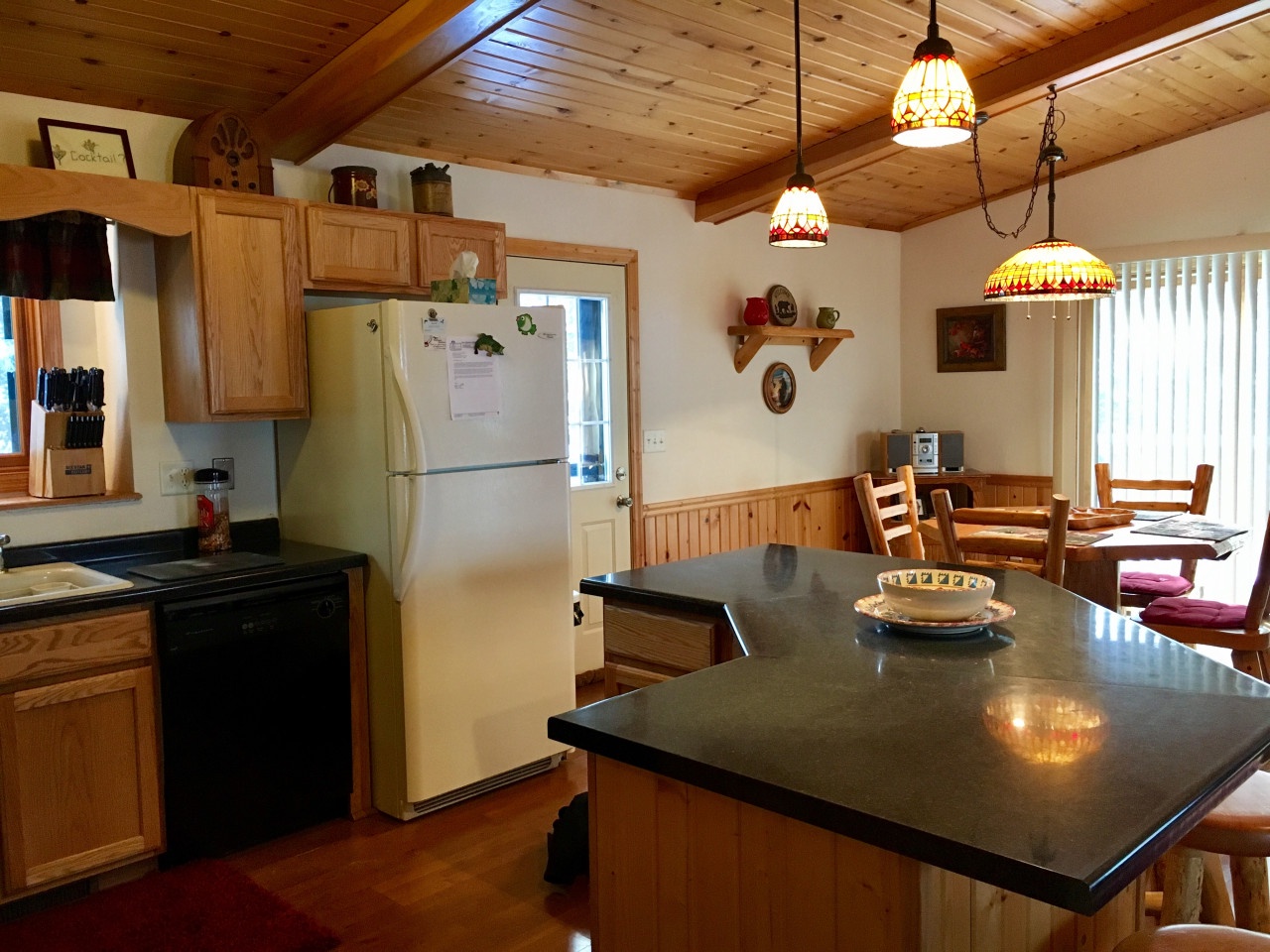 Your cozy mountain kitchen features granite countertops, warm wood cabinets, and charming pendant lighting for memorable meal preparations.