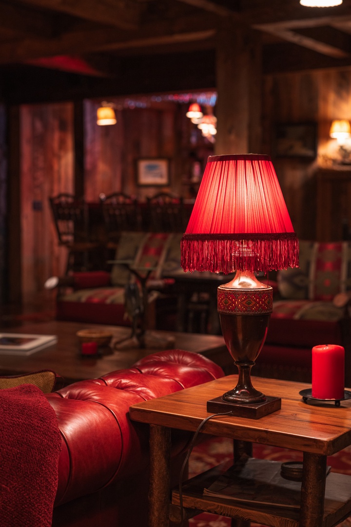 Sink into plush leather seating surrounded by warm lamplight and rich wood accents in this inviting lounge space.