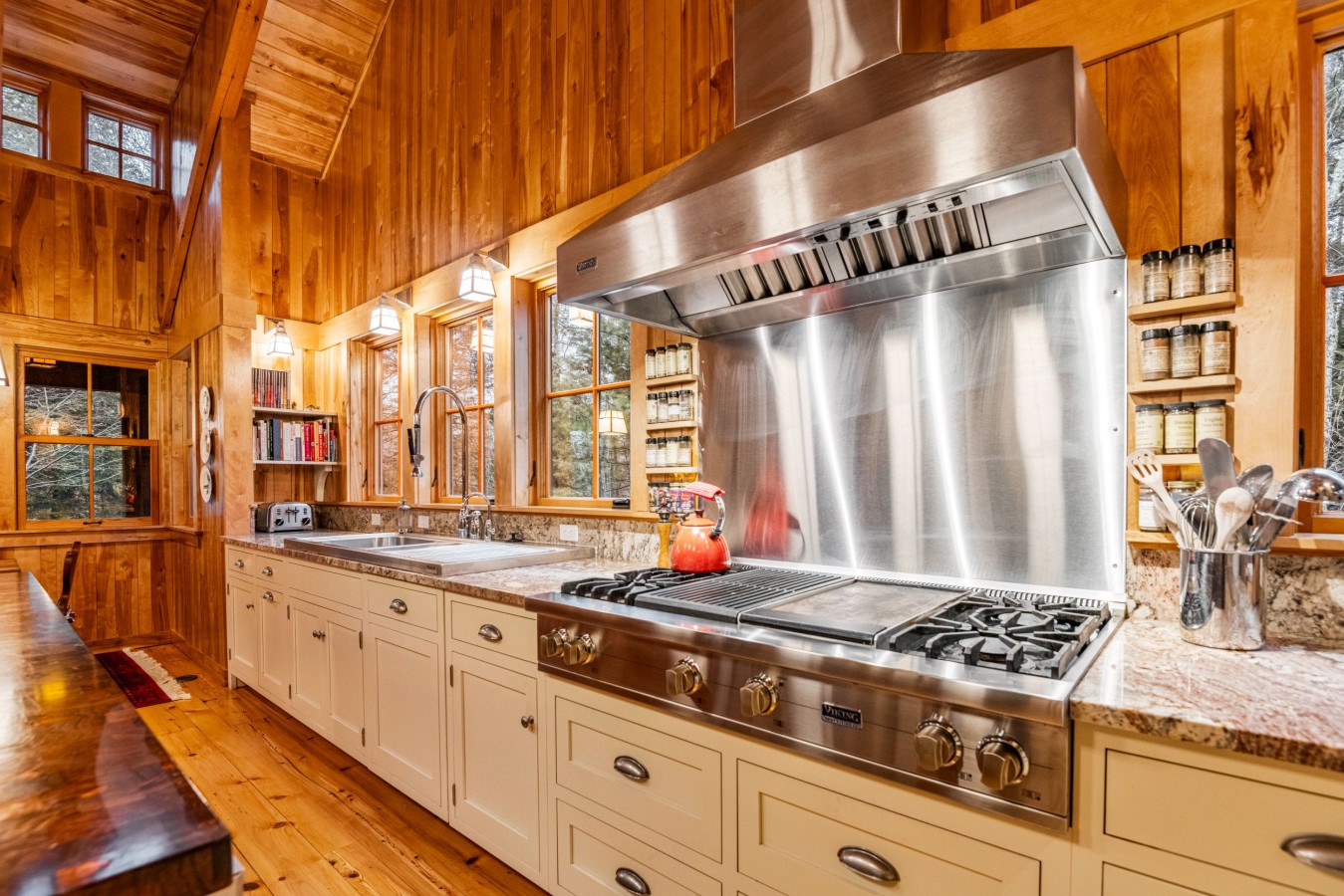Your gourmet kitchen features professional-grade stainless steel appliances and warm wood beams, creating the perfect space for culinary adventures.