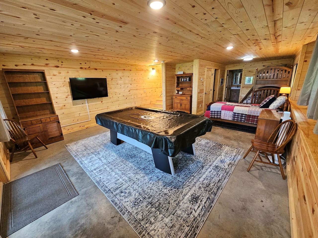 Your rustic game room features warm wood ceilings, pool table for friendly competition, and cozy bunk beds perfect for family fun.