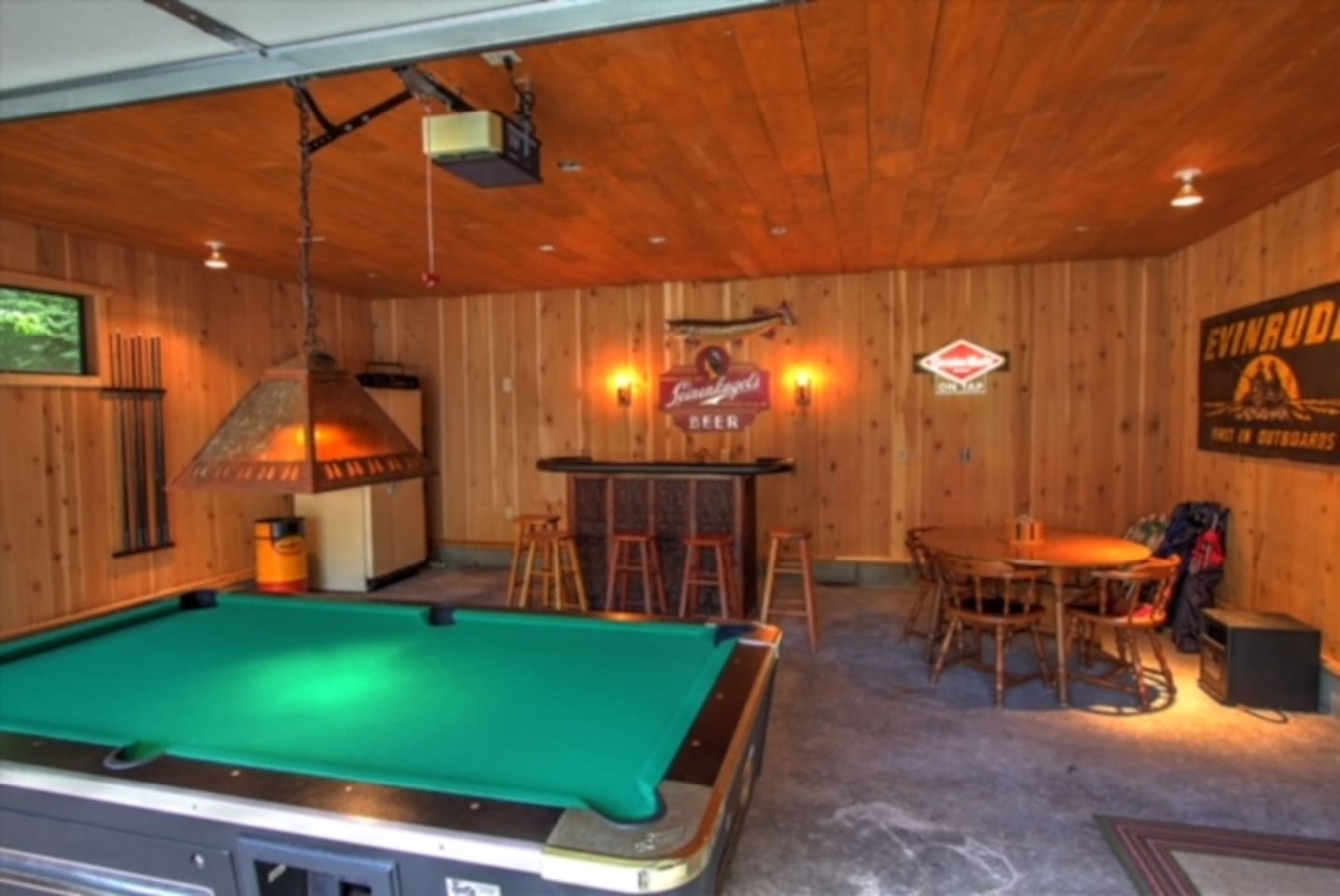 Unwind in your private game room with pool table, bar seating, and cozy dining nook—perfect for evening entertainment.