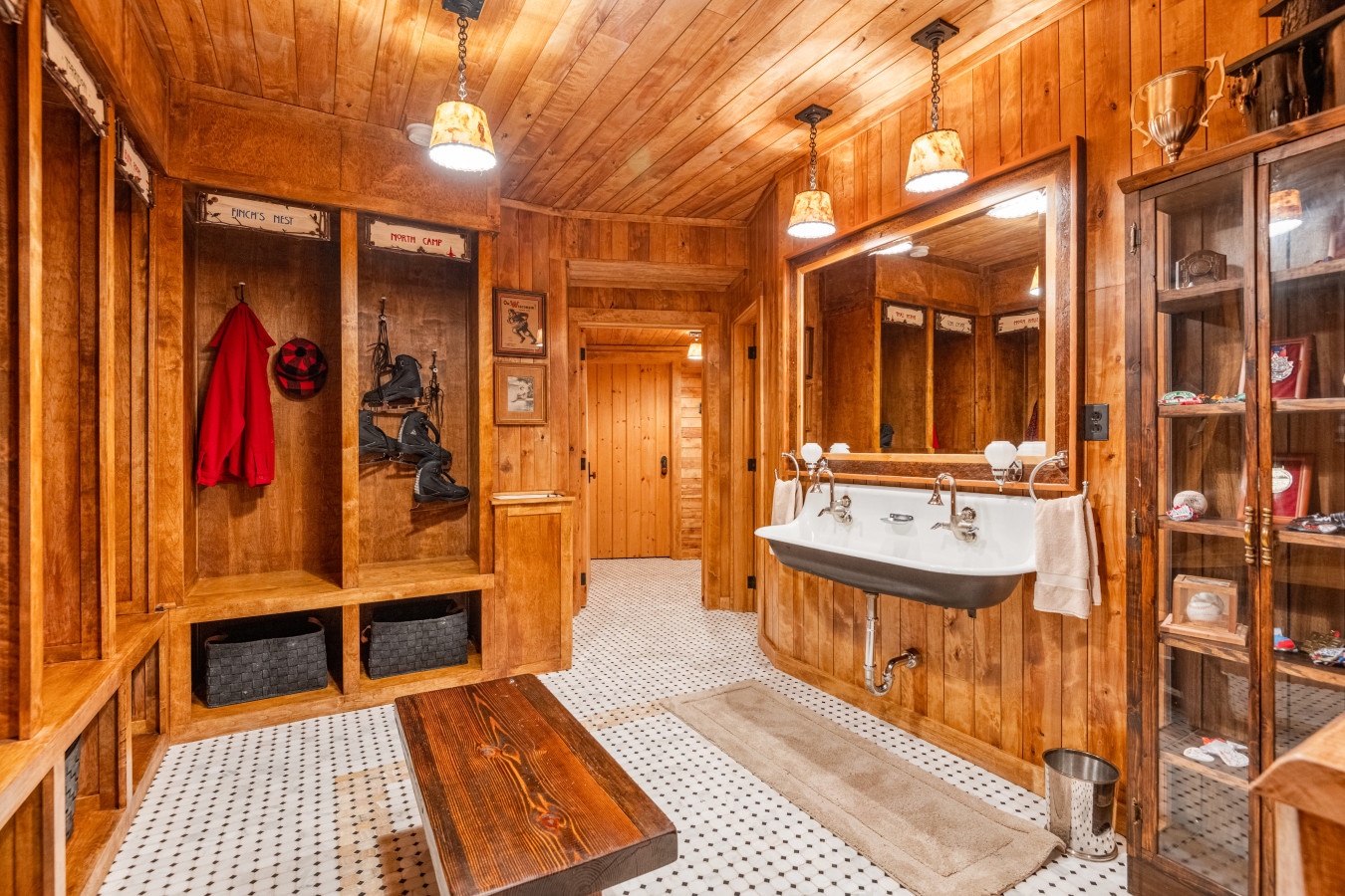 Step into your rustic wood-paneled mudroom with vintage sink and built-in storage lockers for all your adventure gear.