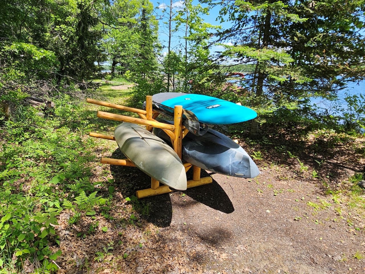 Adventure awaits with complimentary kayaks ready for your lake exploration, perfectly positioned among the peaceful wooded shoreline.