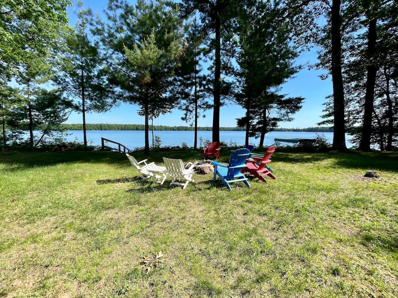 Settle into your lakefront haven with colorful Adirondack chairs perfectly positioned for morning coffee and sunset views over pristine waters.