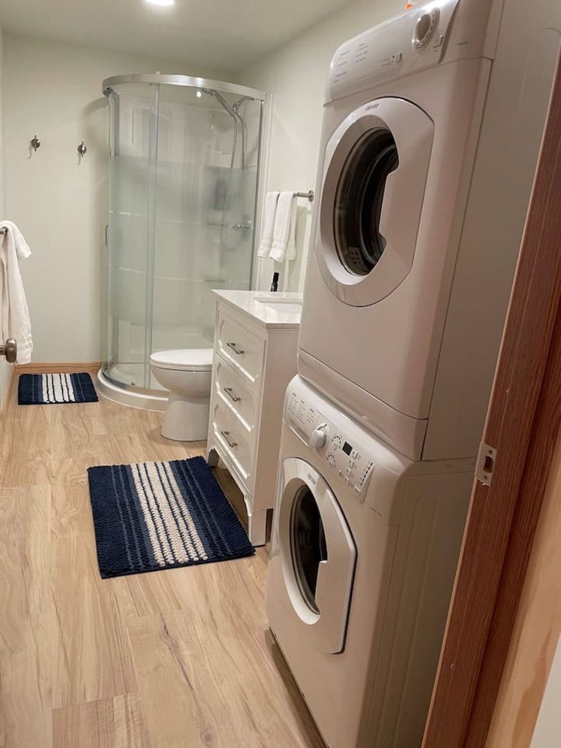 Your private washer and dryer keep you fresh throughout your stay, while the glass shower and vanity complete this convenient space.