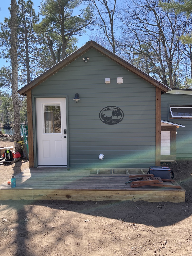 Charming green cottage with historic character welcomes you home.