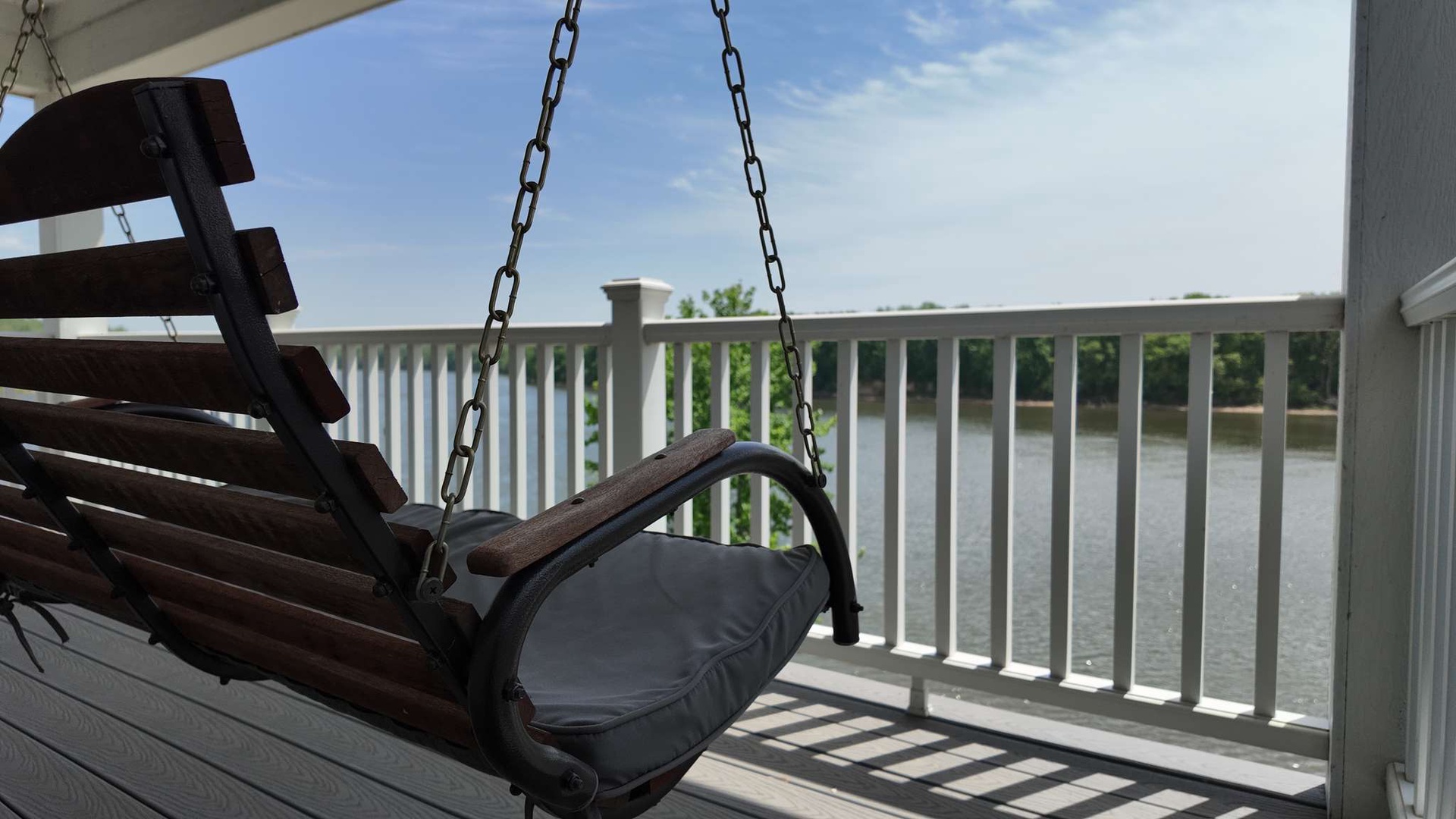 Swing gently on this peaceful porch while watching the lake sparkle below—your perfect spot for morning coffee or evening relaxation.