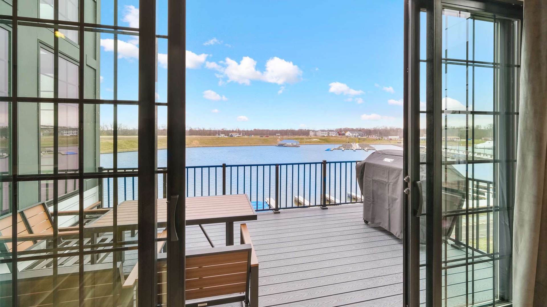 Step onto your private deck where lake views stretch endlessly before you, complete with outdoor seating and BBQ for perfect waterfront dining.