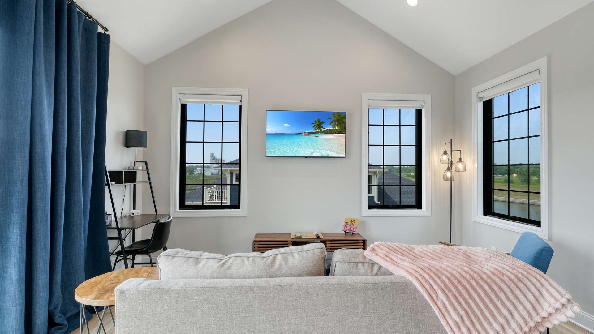 Relax in your bright living room with soaring ceilings, cozy seating, and windows that frame peaceful countryside views.