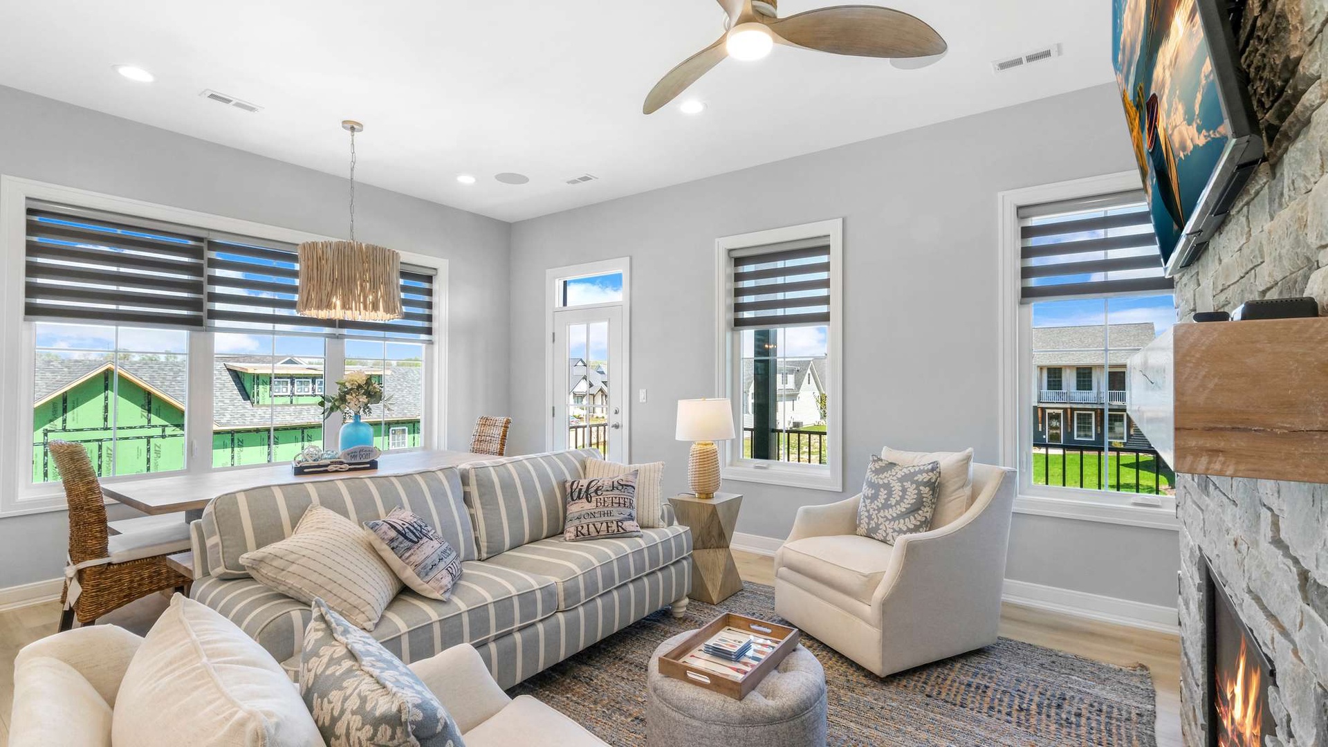 Relax in your bright living space with cozy striped sofa, fireplace, and views of the colorful neighborhood below.