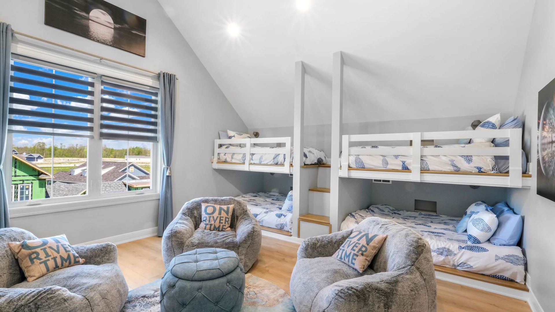 Your kids will love this cozy bunk room with comfy bean bags and playful coastal bedding - perfect for adventure-filled nights and lazy morning stories.