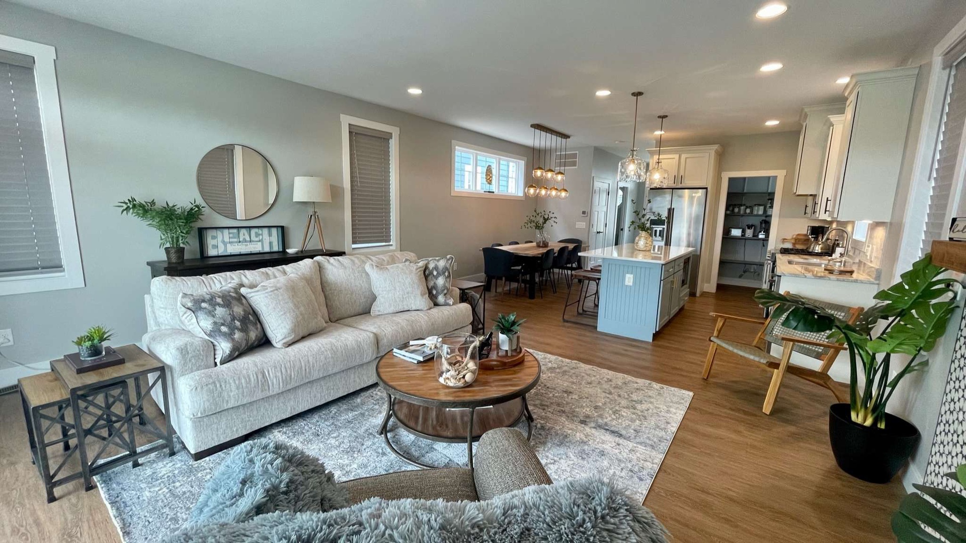 Sink into the plush sofa in this open-concept space where your kitchen flows seamlessly into your living and dining areas, perfect for relaxing.