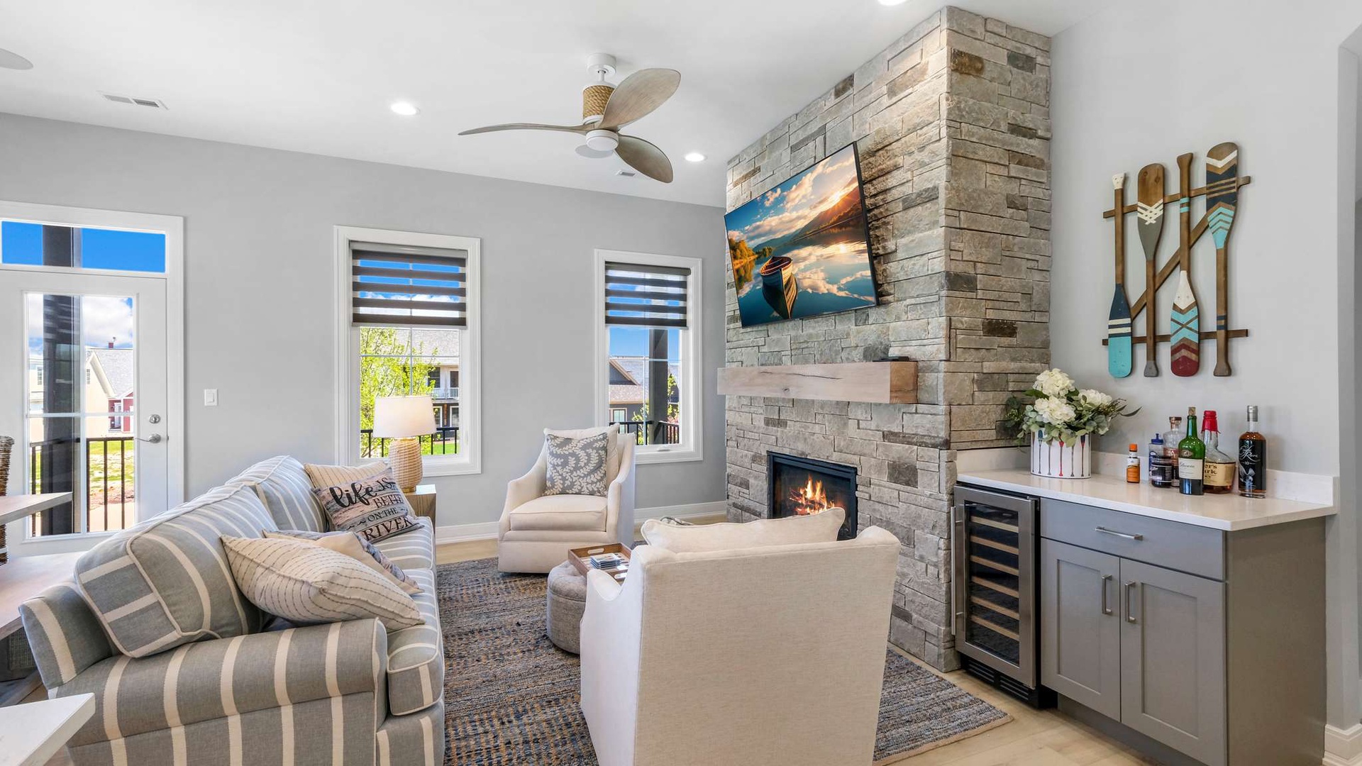 Cozy up by the stone fireplace while enjoying drinks from your wet bar in this stylishly appointed living room.