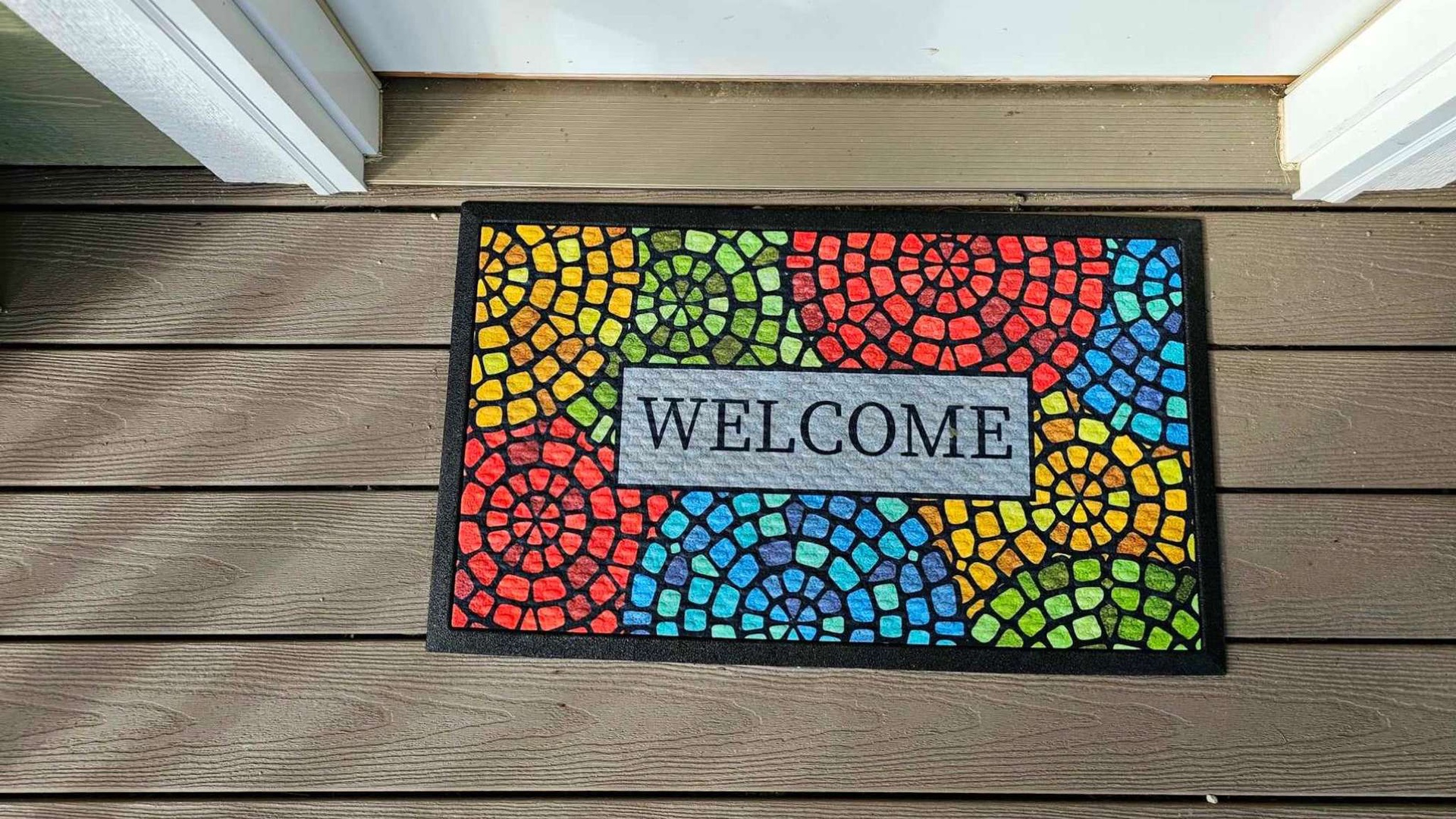 Step onto your private deck and feel instantly welcomed by this vibrant mosaic doormat, setting a cheerful tone for your stay.